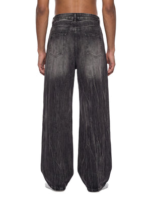STILL. Men's Vintage Wash Wide Leg Jeans, worn by a model