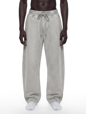 STILL. Unisex Vintage Wash Barrel Leg Fleece Sweatpants, worn by a model