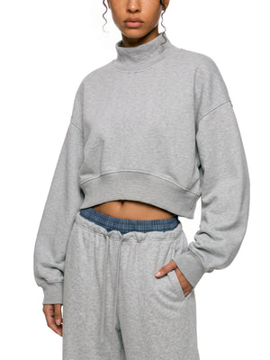 STILL. Women's Crop Mock Neck Sweatshirt, worn by a model