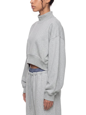 STILL. Women's Crop Mock Neck Sweatshirt, worn by a model