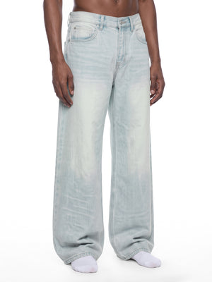 STILL. Men's Light Wash Wide Leg Jeans, worn by a model