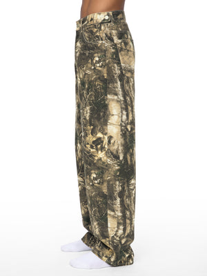 STILL. Men's Tree Camo Barrel Leg Pants, worn by a model