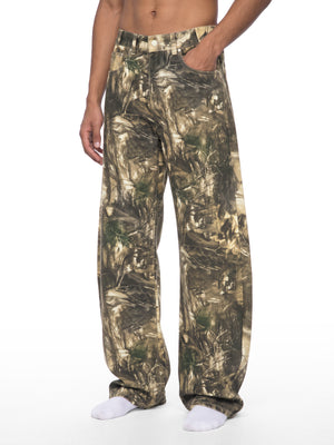 STILL. Men's Tree Camo Barrel Leg Pants, worn by a model