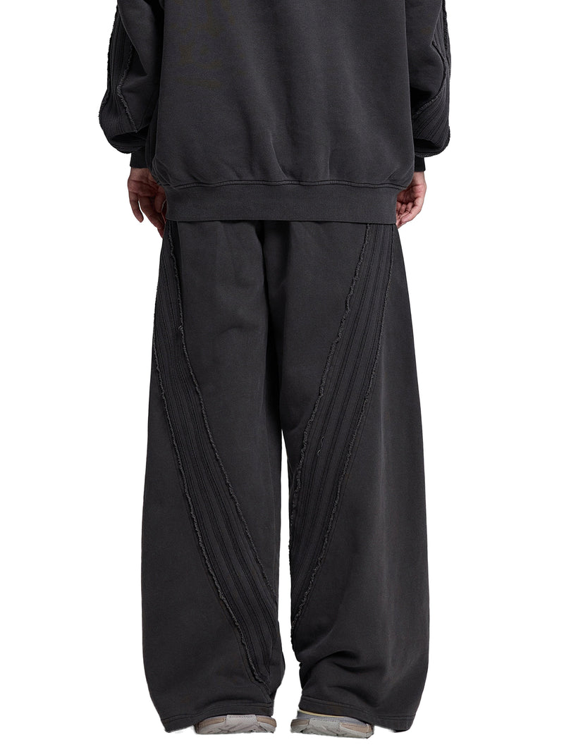 STILL. Vintage Washed Tape Raw Edge Sweatpants, worn by a model