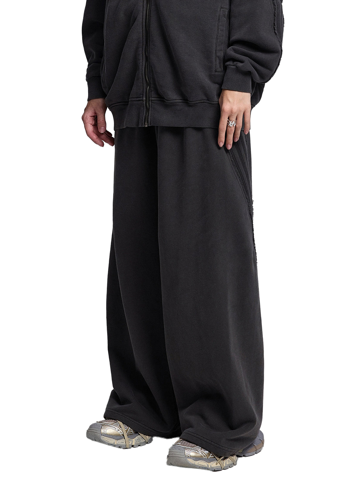 STILL. Vintage Washed Tape Raw Edge Sweatpants, worn by a model