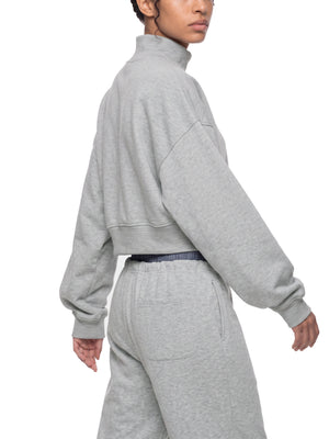 STILL. Women's Crop Mock Neck Sweatshirt, worn by a model