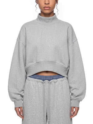 STILL. Women's Crop Mock Neck Sweatshirt, worn by a model