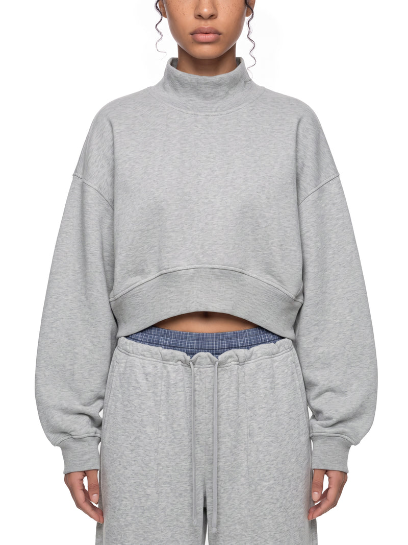 STILL. Women's Crop Mock Neck Sweatshirt, worn by a model