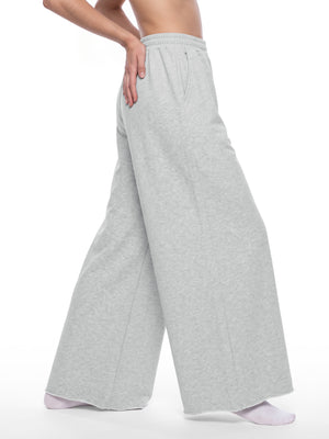 STILL. Women's Raw Edge Wide Leg Sweatpants, worn by a model