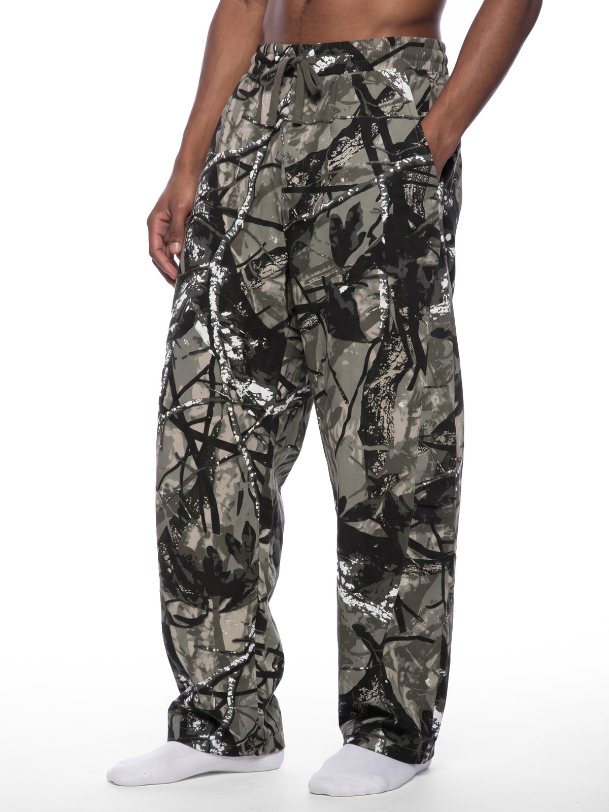 STILL. Unisex Tree Camo Barrel Leg Pants, worn by a model