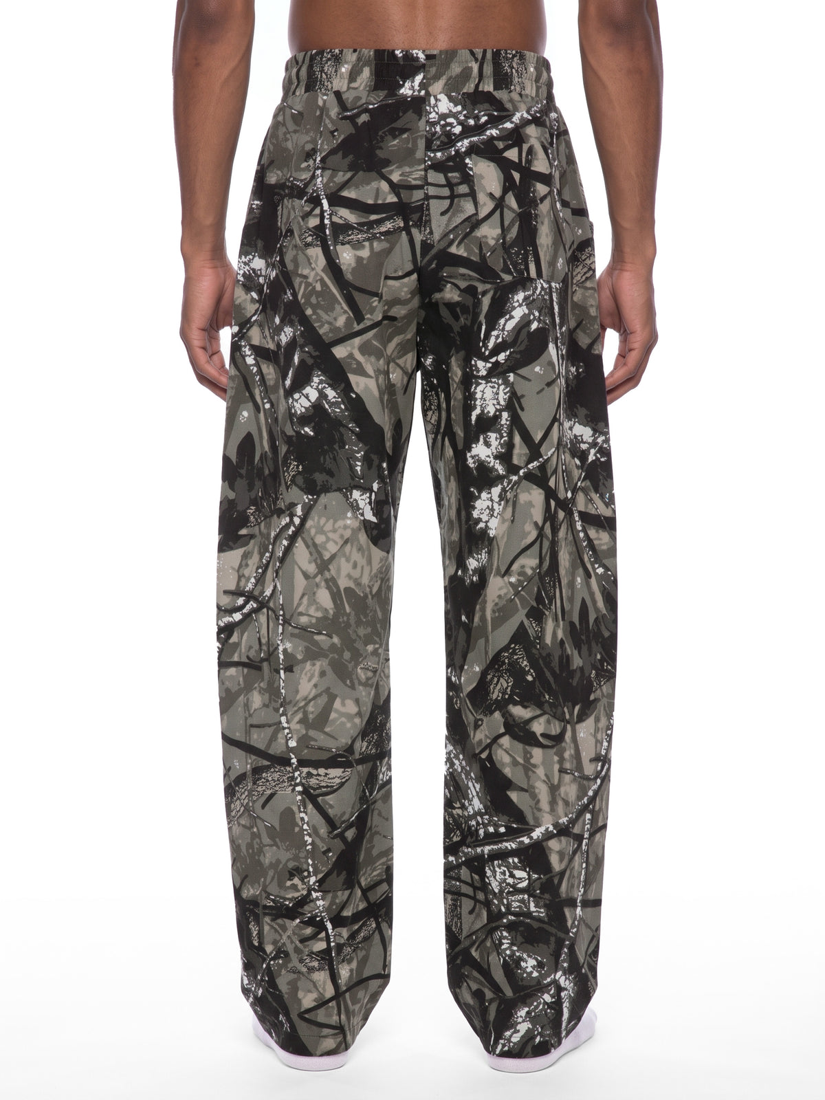 STILL. Unisex Tree Camo Barrel Leg Pants, worn by a model