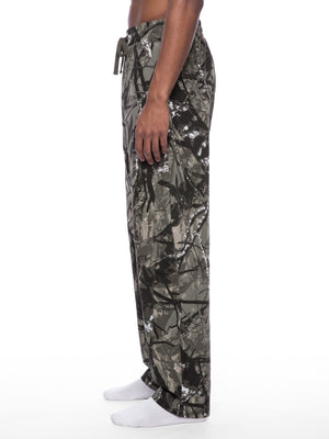 STILL. Unisex Tree Camo Barrel Leg Pants, worn by a model