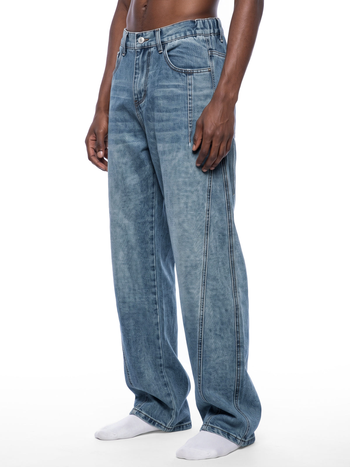 STILL. Unisex Vintage Wash Barrel Leg Jeans, worn by a model