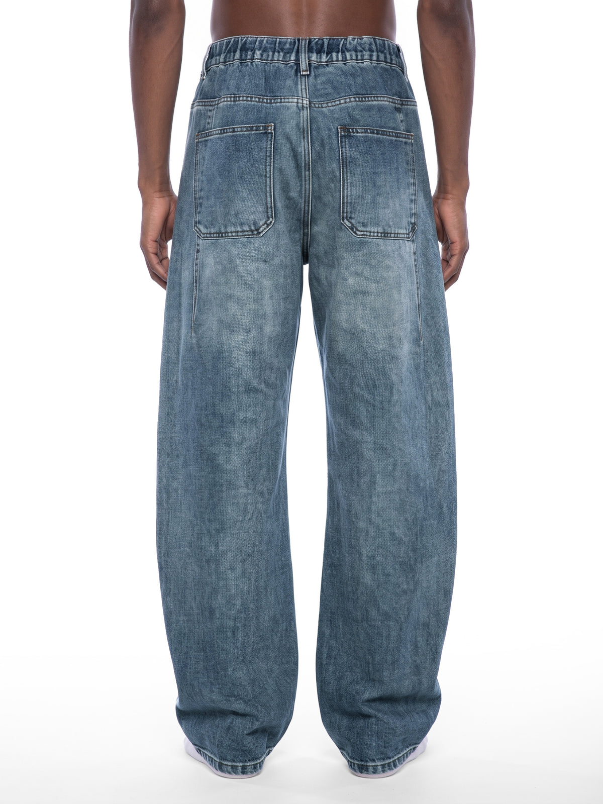 STILL. Unisex Vintage Wash Barrel Leg Jeans, worn by a model