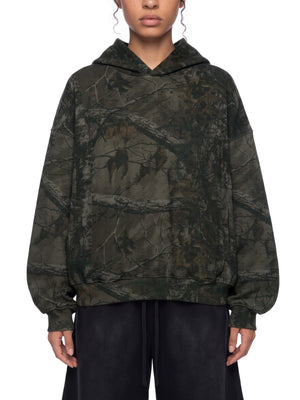 STILL. Unisex Waffle Tree Camo Boxy Hoodie, worn by a model