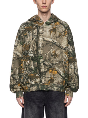 STILL. Unisex Waffle Tree Camo Boxy Hoodie, worn by a model