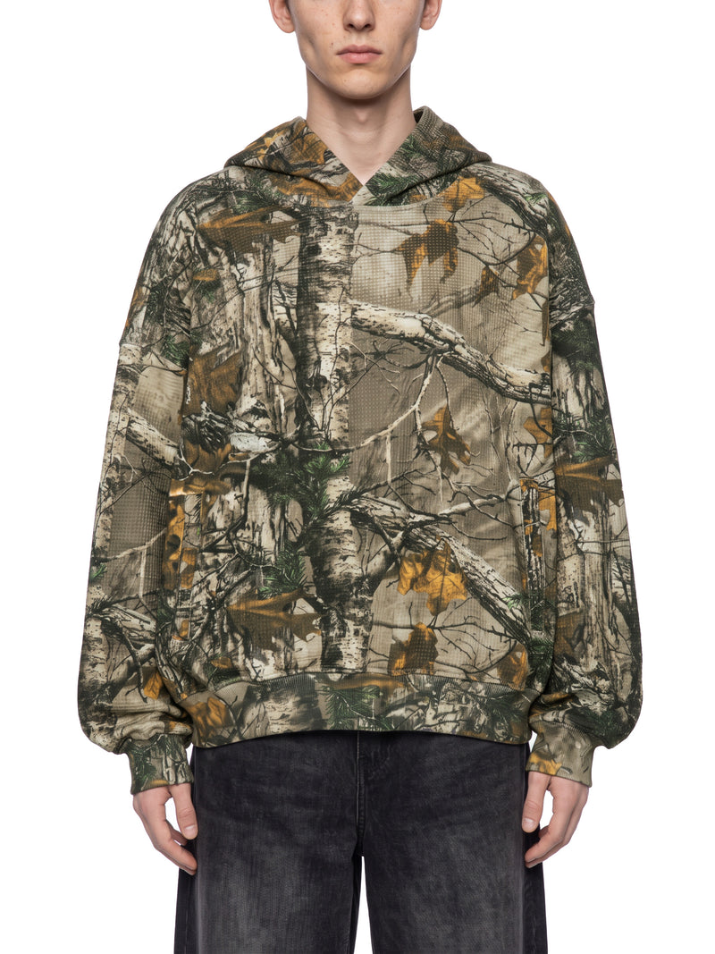 STILL. Unisex Waffle Tree Camo Boxy Hoodie, worn by a model